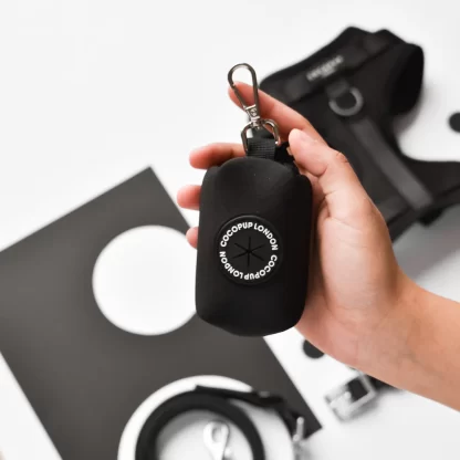 STYLISH DESIGN: Black polyester poop bag holder with sleek circular logo design, perfect for carrying waste bags in style